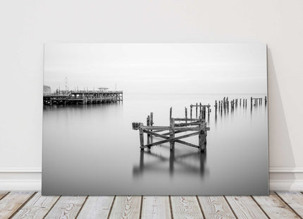 Coastal pier in calm waters. Canvas picture print in black and white.