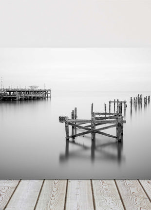 Coastal pier in calm waters. Canvas picture print in black and white.