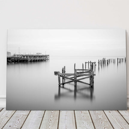 Coastal pier in calm waters. Canvas picture print in black and white.
