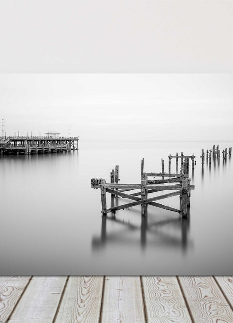 Coastal pier in calm waters. Canvas picture print in black and white.