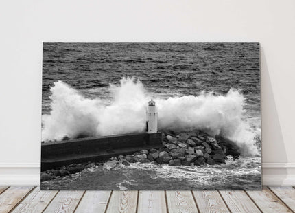 Waves crashing over a lighthouse black and white canvas picture print