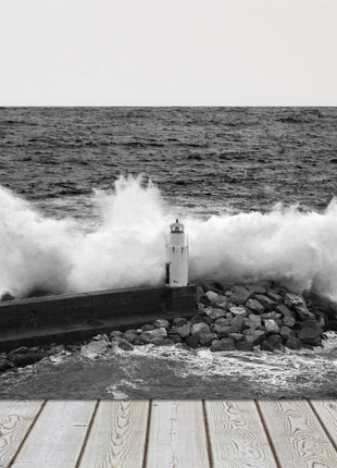 Waves crashing over a lighthouse black and white canvas picture print