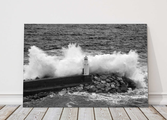 Waves crashing over a lighthouse black and white canvas picture print