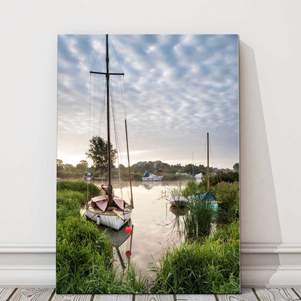 Sailing boats moored on the riverbank at sunrise. Canvas picture Print.