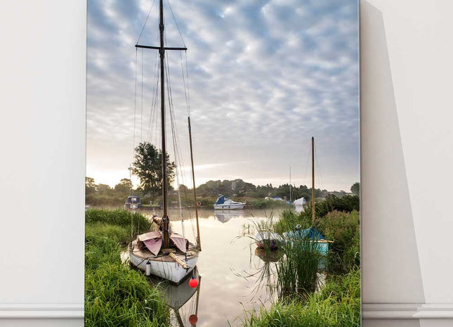 Sailing boats moored on the riverbank at sunrise. Canvas picture Print.