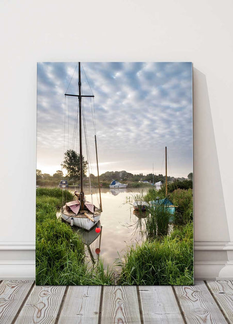 Sailing boats moored on the riverbank at sunrise. Canvas picture Print.