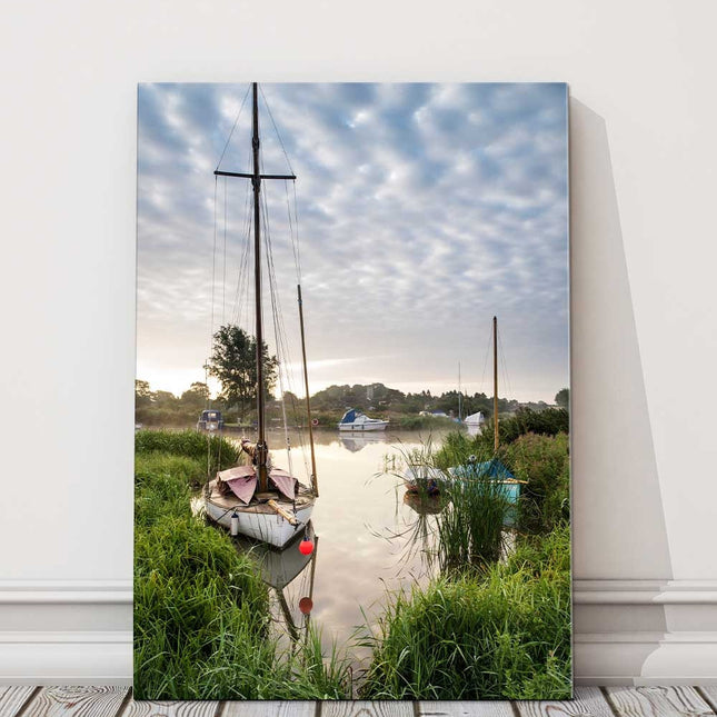 Sailing boats moored on the riverbank at sunrise. Canvas picture Print.