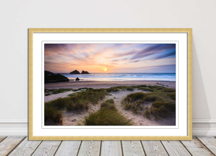 Holywell bay at sunset. Framed picture print with a choice of frame colours.