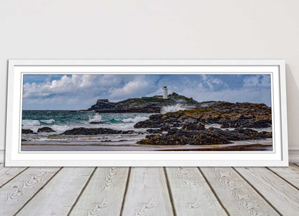 Godrevy Lighthouse with breaking waves at the shore. Cornwall. Framed picture