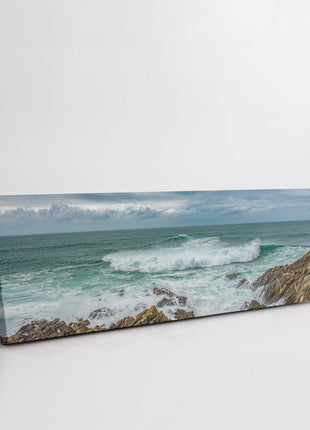 Breaking wave on the rocky Cornish coast. Panoramic Canvas picture print.