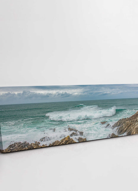 Breaking wave on the rocky Cornish coast. Panoramic Canvas picture print.