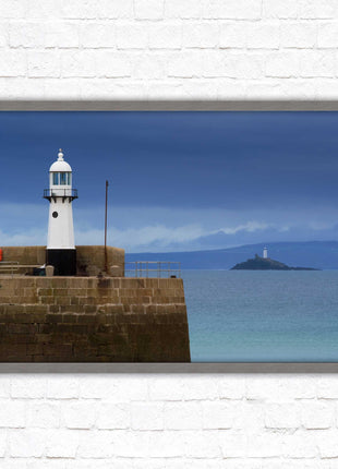 St Ives harbour lighthouse. Framed picture print with a choice of frame colours. Beach seascape