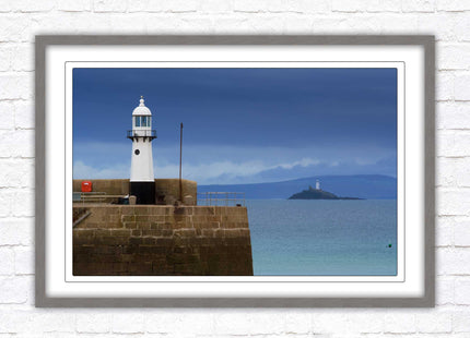 St Ives harbour lighthouse. Framed picture print with a choice of frame colours. Beach seascape