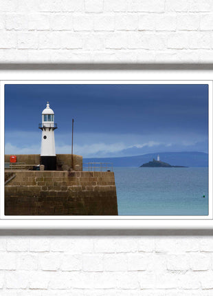 St Ives harbour lighthouse. Framed picture print with a choice of frame colours. Beach seascape