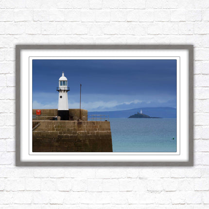 St Ives harbour lighthouse. Framed picture print with a choice of frame colours. Beach seascape