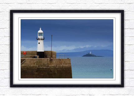 St Ives harbour lighthouse. Framed picture print with a choice of frame colours. Beach seascape