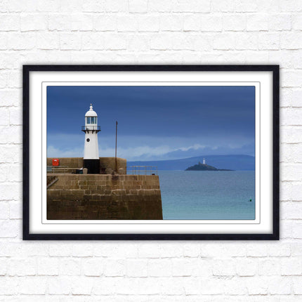 St Ives harbour lighthouse. Framed picture print with a choice of frame colours. Beach seascape