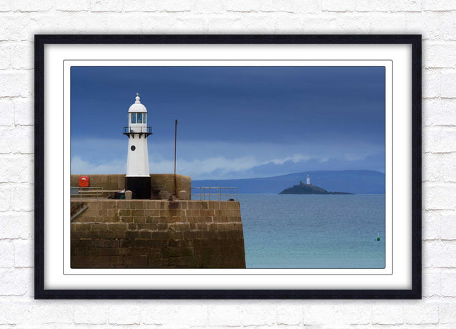 St Ives harbour lighthouse. Framed picture print with a choice of frame colours. Beach seascape