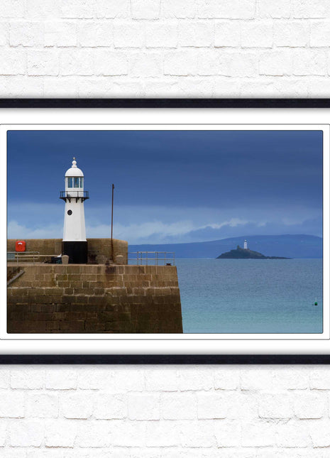 St Ives harbour lighthouse. Framed picture print with a choice of frame colours. Beach seascape