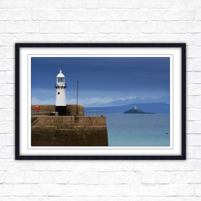 St Ives harbour lighthouse. Framed picture print with a choice of frame colours. Beach seascape
