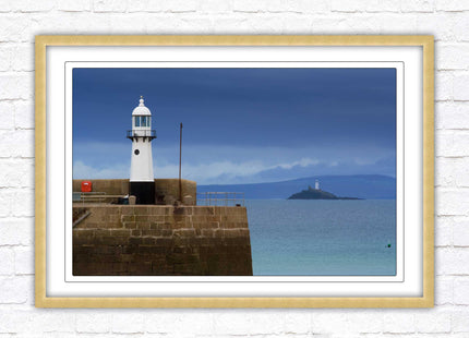 St Ives harbour lighthouse. Framed picture print with a choice of frame colours. Beach seascape