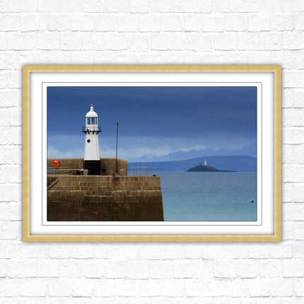 St Ives harbour lighthouse. Framed picture print with a choice of frame colours. Beach seascape