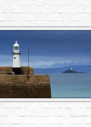 St Ives harbour lighthouse. Framed picture print with a choice of frame colours. Beach seascape