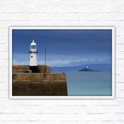 St Ives harbour lighthouse. Framed picture print with a choice of frame colours. Beach seascape