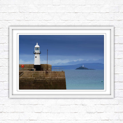 St Ives harbour lighthouse. Framed picture print with a choice of frame colours. Beach seascape