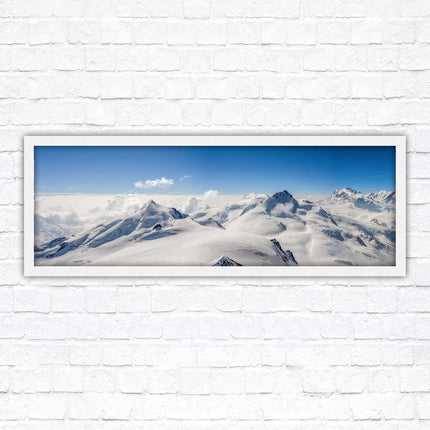 Swiss Alps mountain landscape. Panoramic framed picture print. Vibrant blue and white image. Choice of frame colours.