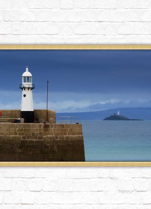 St Ives harbour lighthouse. Framed picture print with a choice of frame colours. Beach seascape