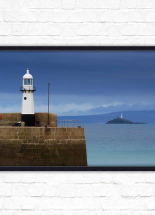 St Ives harbour lighthouse. Framed picture print with a choice of frame colours. Beach seascape