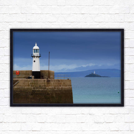 St Ives harbour lighthouse. Framed picture print with a choice of frame colours. Beach seascape