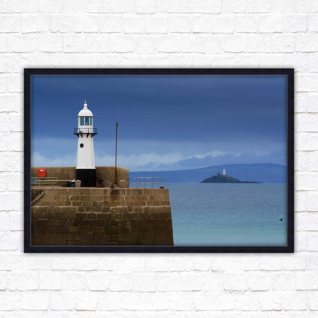 St Ives harbour lighthouse. Framed picture print with a choice of frame colours. Beach seascape