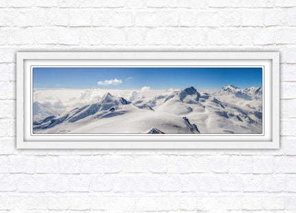Swiss Alps mountain landscape. Panoramic framed picture print. Vibrant blue and white image. Choice of frame colours.